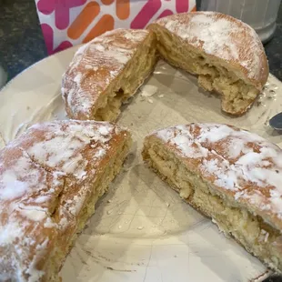  a half eaten doughnut on a plate