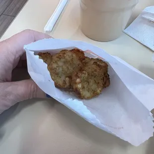  a hand holding a piece of food