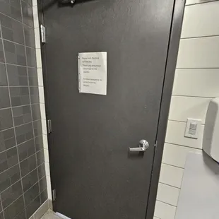  a closed door in a public restroom