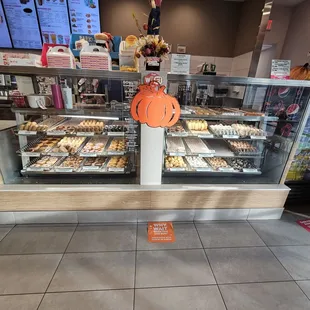  a display case of donuts in a bakery