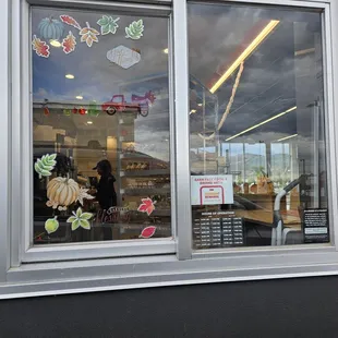  the reflection of a woman in a store window