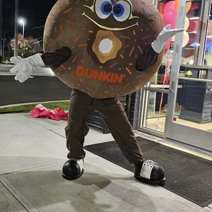  a man in a dunkin donut costume