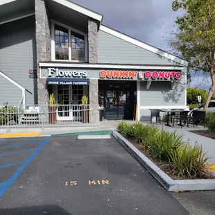  the entrance to a dunkin donuts restaurant