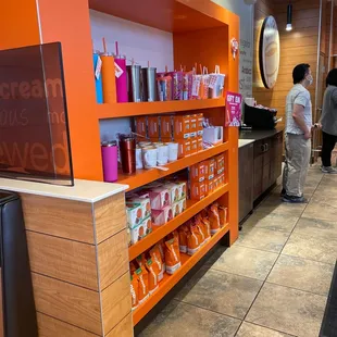  a woman standing at a counter in a dunkin donuts store