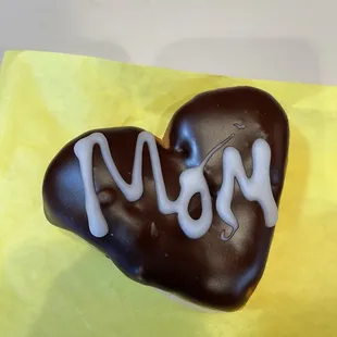  a chocolate heart with the word mom written on it