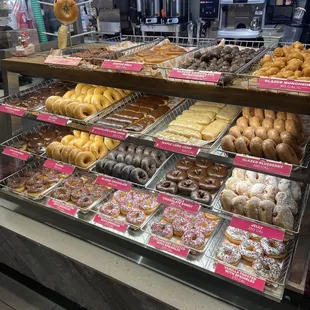  a variety of donuts in a display case