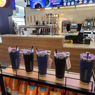 a display of dunkin donuts and coffee cups
