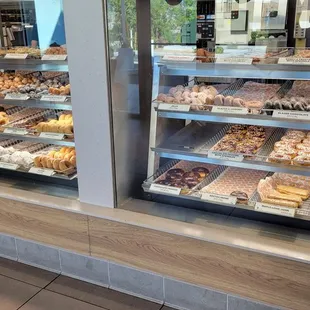  a variety of donuts in a display case