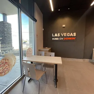  a table and chairs in front of a window