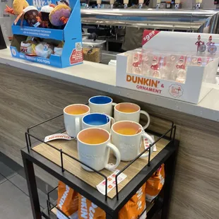  cups of coffee on a cart in a coffee shop