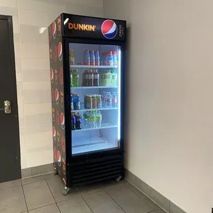  a soda cooler in a room