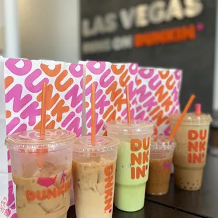  a row of dunkin'donuts in plastic cups