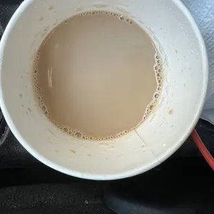 a cup of coffee in a car seat