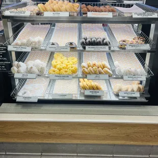 a variety of donuts in a display case
