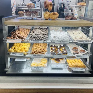 a variety of donuts in a display case
