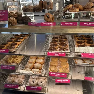  a variety of donuts in a display case
