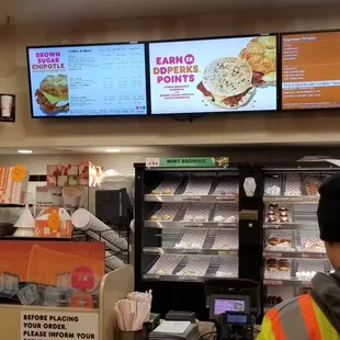 a man at the counter in a dunkin donuts store