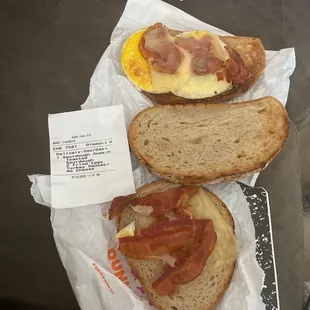  two sandwiches with bacon and eggs