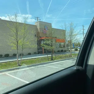  a view of a parking lot from inside a car