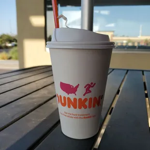  a cup of dunkin donuts on a table