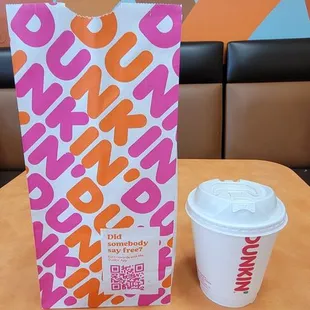  a cup of coffee and a box of dunkin donuts