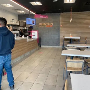  a man walking through a restaurant