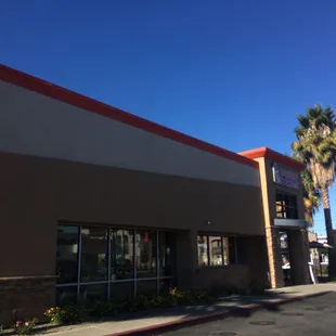  a storefront with palm trees in the background