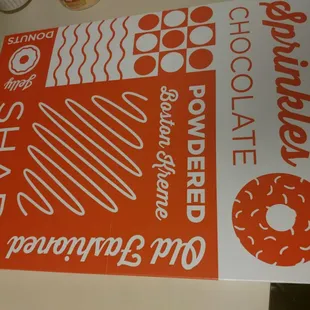  an orange and white sign with a donut on it