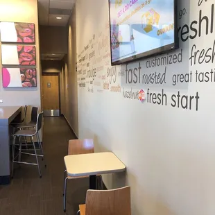  a long hallway with tables and chairs