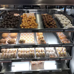  a variety of donuts in a display case