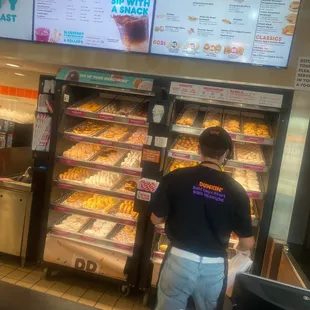  a man working in a donut shop