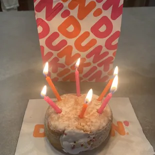 Vanilla cream filled powdered donut (with birthday candles)