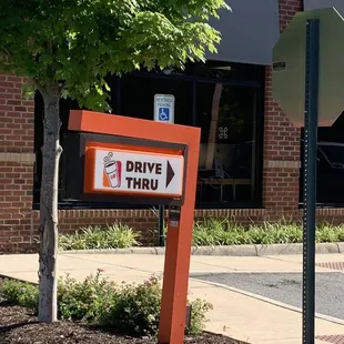  a drive thru sign in front of a store
