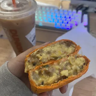  a person holding a half eaten sandwich