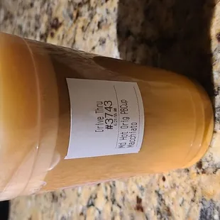 Lukewarm coffee served in a cold drink cup.