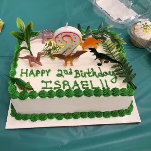  a birthday cake with a dinosaur on it