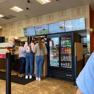  a line of people waiting at the counter