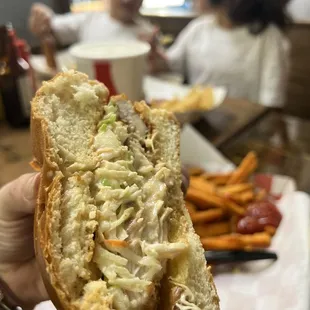 a person holding a sandwich