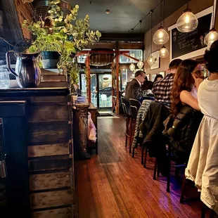 people sitting at tables in a restaurant
