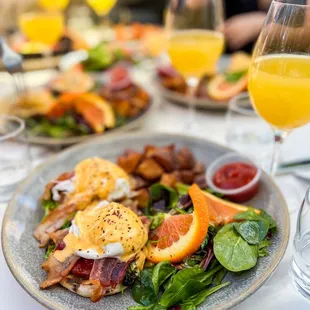 a plate of food and a glass of orange juice