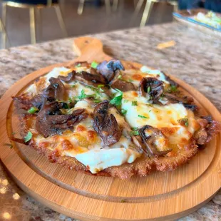 a pizza with mushrooms and cheese
