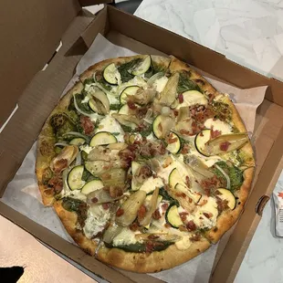 Make your own: Duomo crust, pesto sauce, fresh mozzarella, artichokes, bacon, zucchini, spinach, garlic, and ricotta cheese.