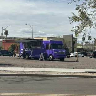 a purple bus parked in a parking lot