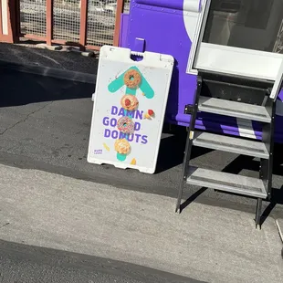 a donut truck and a sign