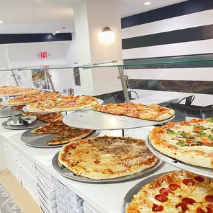 a variety of pizzas on display