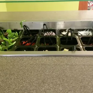 a salad bar with a variety of salads