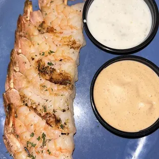 Delicious, juicy, well seasoned and sautéed grilled shrimps accompanied by spicy and tart sauces