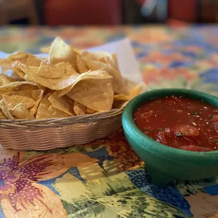 a bowl of salsa and chips