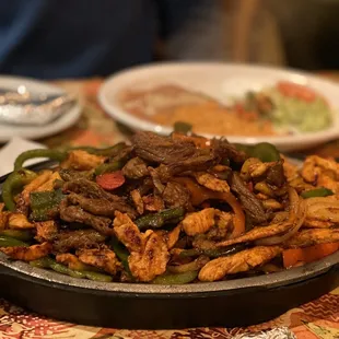 Double beef, chicken, and shrimp fajitas