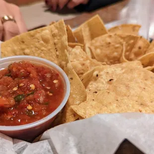 a basket of chips and salsa